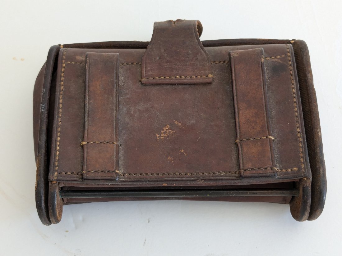 Back of a worn leather case with two belt loops, Mystery Lot Hint #1